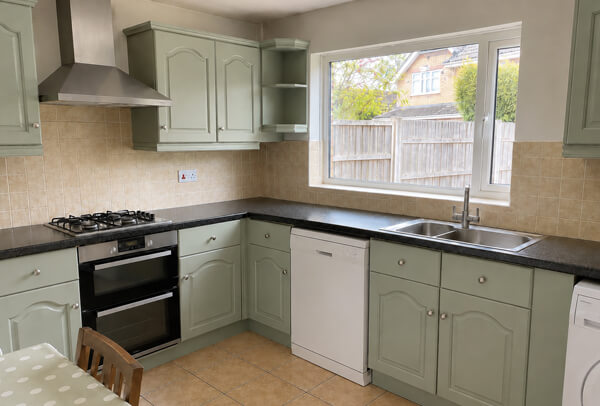 Muted blue kitchen cupboards after painting in Hatfield