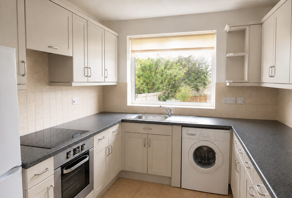 Soft warm grey painted kitchen cupboards after repainting in Hatfield