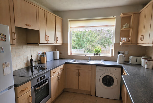 Yellowed kitchen units before repainting in Hatfield
