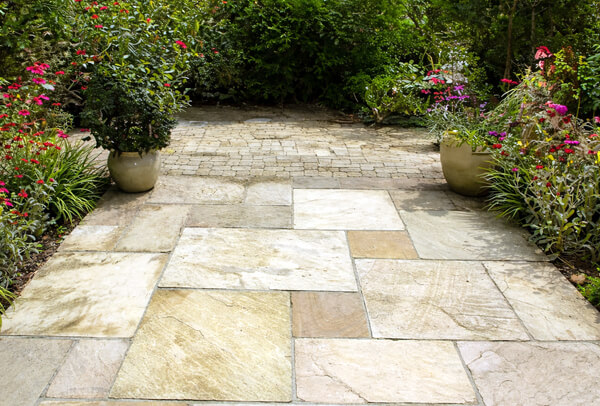 Sandstone patio before cleaning in Milton Keynes