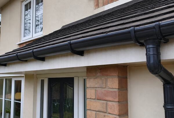 Blocked gutter in Northampton after cleaning, cleared and flowing properly