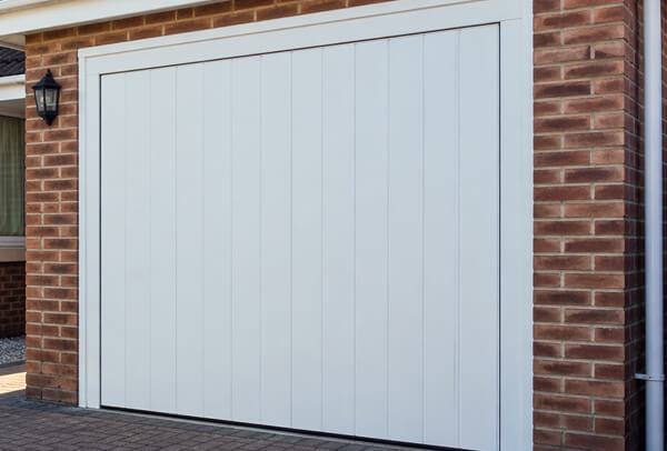 Composite garage door with an older finish before painting
