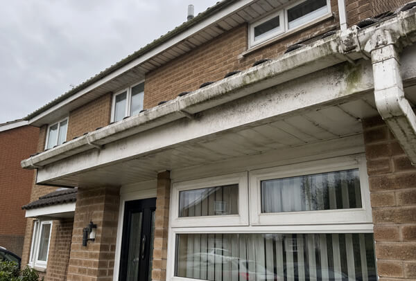 Fascias, soffits and gutters in Northampton before washing, with exterior staining and dirt