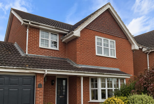 Roofline in Northampton before painting, with faded fascias, soffits and guttering