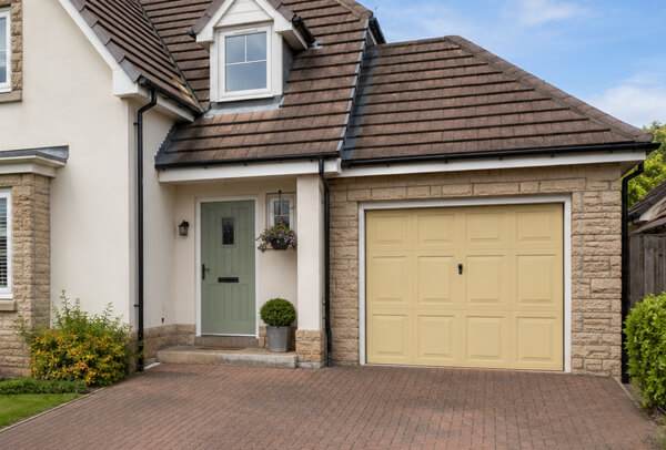 Garage door before painting, with a colour that feels separate from the rest of the house