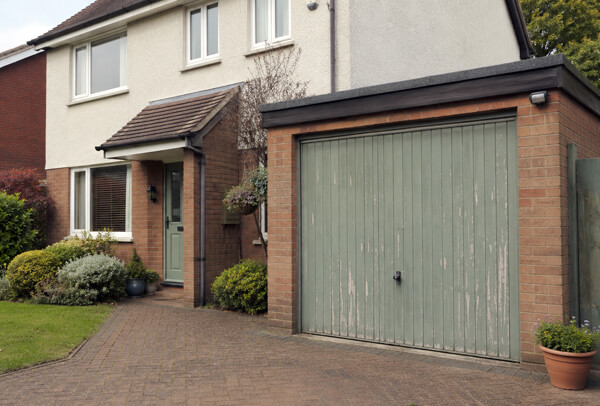 Garage door before preparation, showing a surface ready to be cleaned and repainted