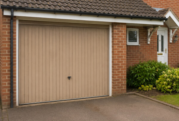 Older garage door before repainting, showing a finish that no longer suits the home
