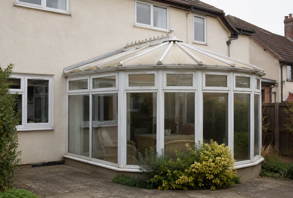 Conservatory frames showing uneven weathering before repainting