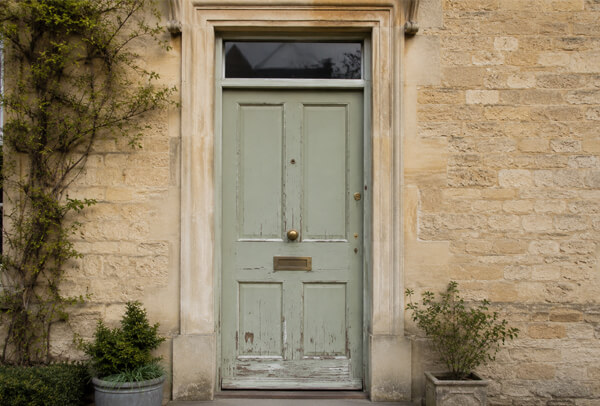 Front door in Oxford before painting, with a faded and dated finish