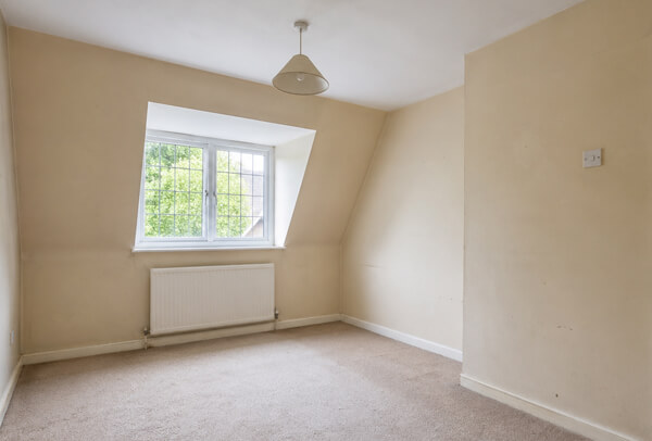 Room in Luton before painting with dull wall colour and tired decoration