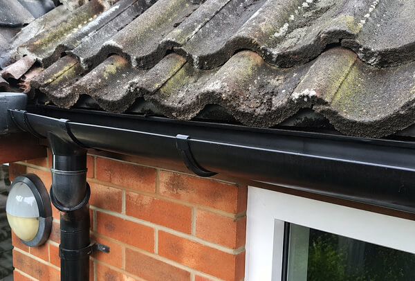 Gutters showing signs of blockage before cleaning in Milton Keynes