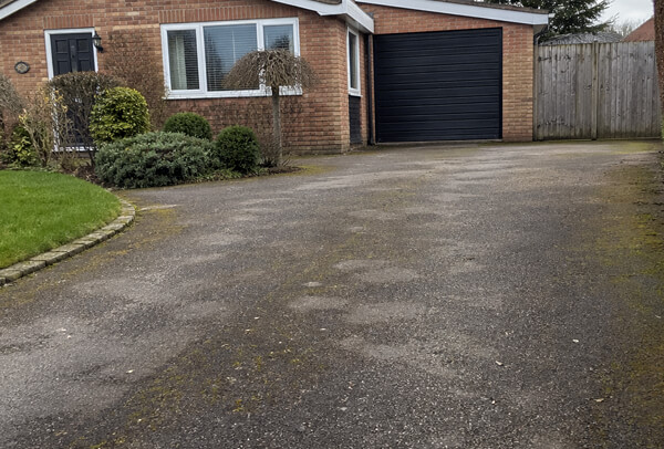 Tarmac driveway in Northampton before cleaning, looking dull and weathered