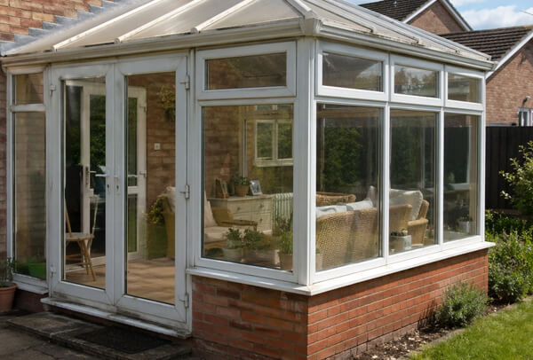 uPVC conservatory in Northampton before painting, with faded white frames