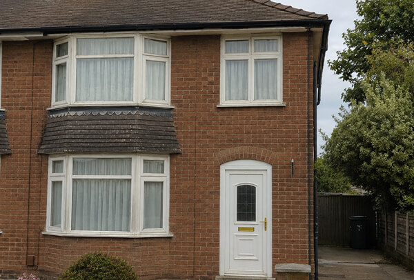 Faded front window frames before repainting in Kettering