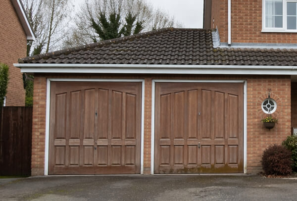 Weathered wooden garage door before repainting
