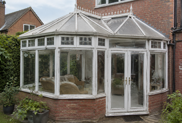 Conservatory with a detailed frame layout before repainting in Bicester