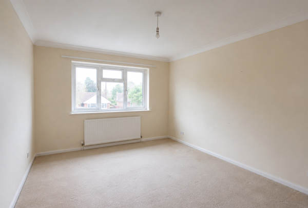 Lived in room in Hatfield before painter and decorator work with tired colours and dull woodwork