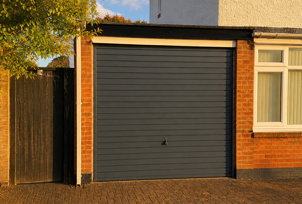 Weathered garage door after repainting in Wellingborough