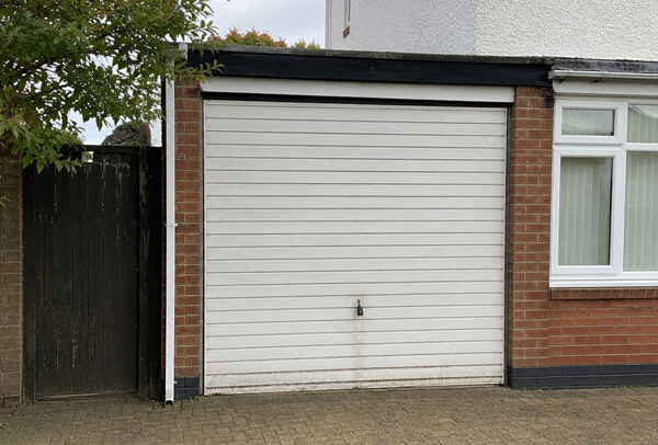Weathered garage door before painting in Wellingborough