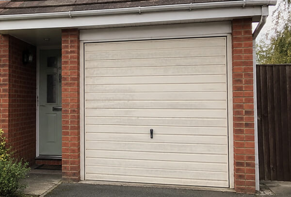 Side hinged garage doors before painting in Wellingborough