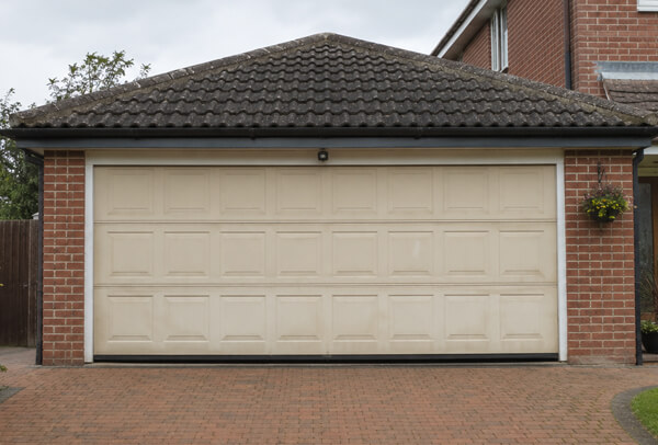 Weather faded garage door before repainting in Wellingborough