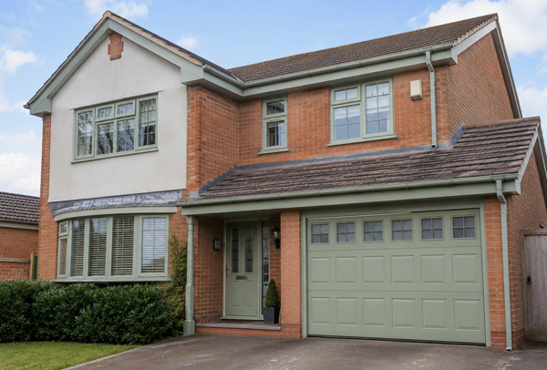 Property exterior in Leighton Buzzard before window frame garage door and roofline painting