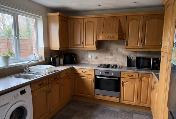 Dated cream kitchen cupboards before painting in Kettering
