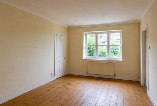 Interior room in Hatfield before decorating with marked walls and tired trim
