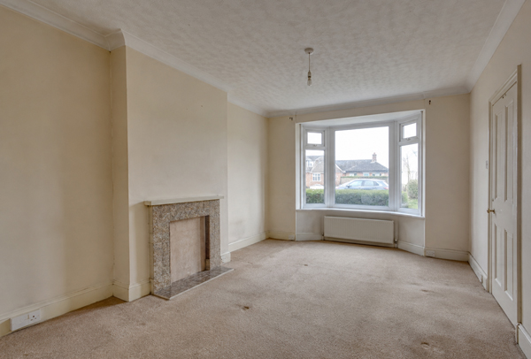 Living room in Stevenage before painting and decorating with dull walls and tired woodwork