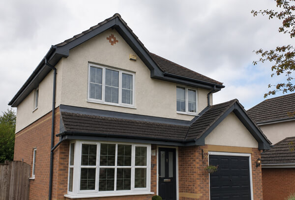 Roofline after repainting in Kettering showing refreshed fascias soffits and guttering