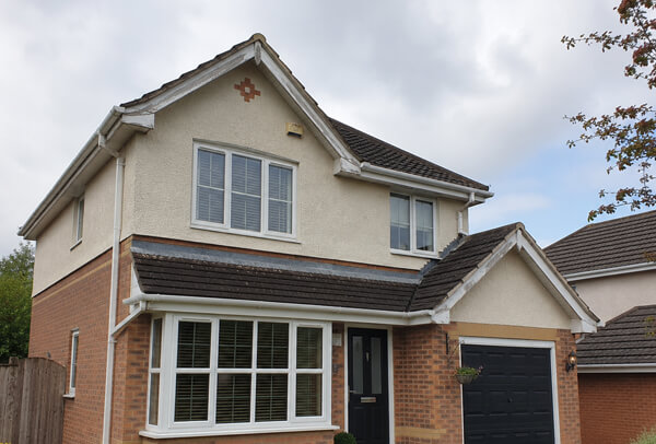 Roofline before repainting in Kettering showing tired fascias soffits and guttering